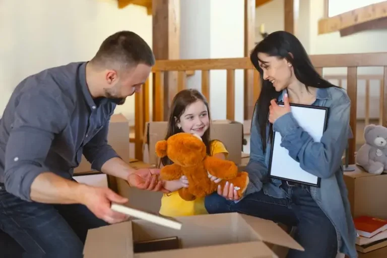 Parents unpacking and giving bear to daughter
