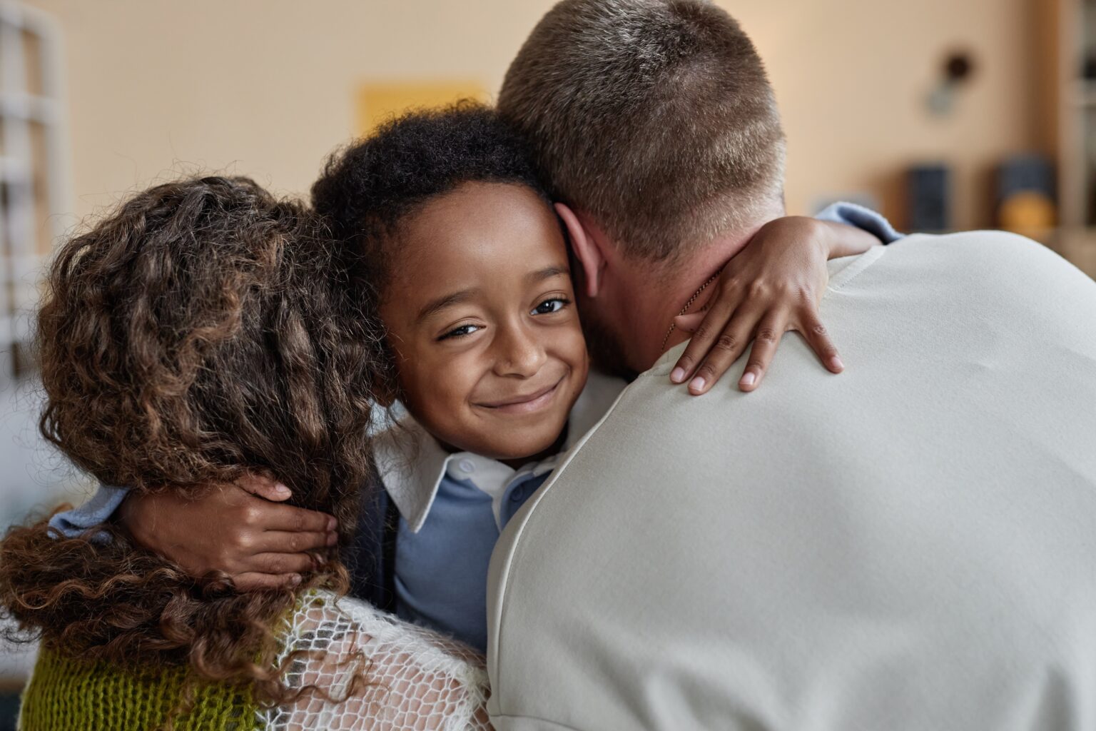 Foster parents hugging their child at home in Georgia